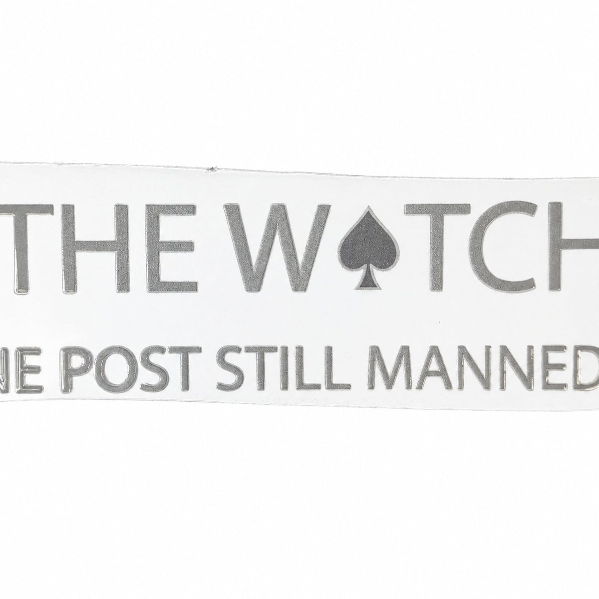 Detail photo of The Watch wordmark with the One Post Still Manned line; the outer edges are outside the photograph.