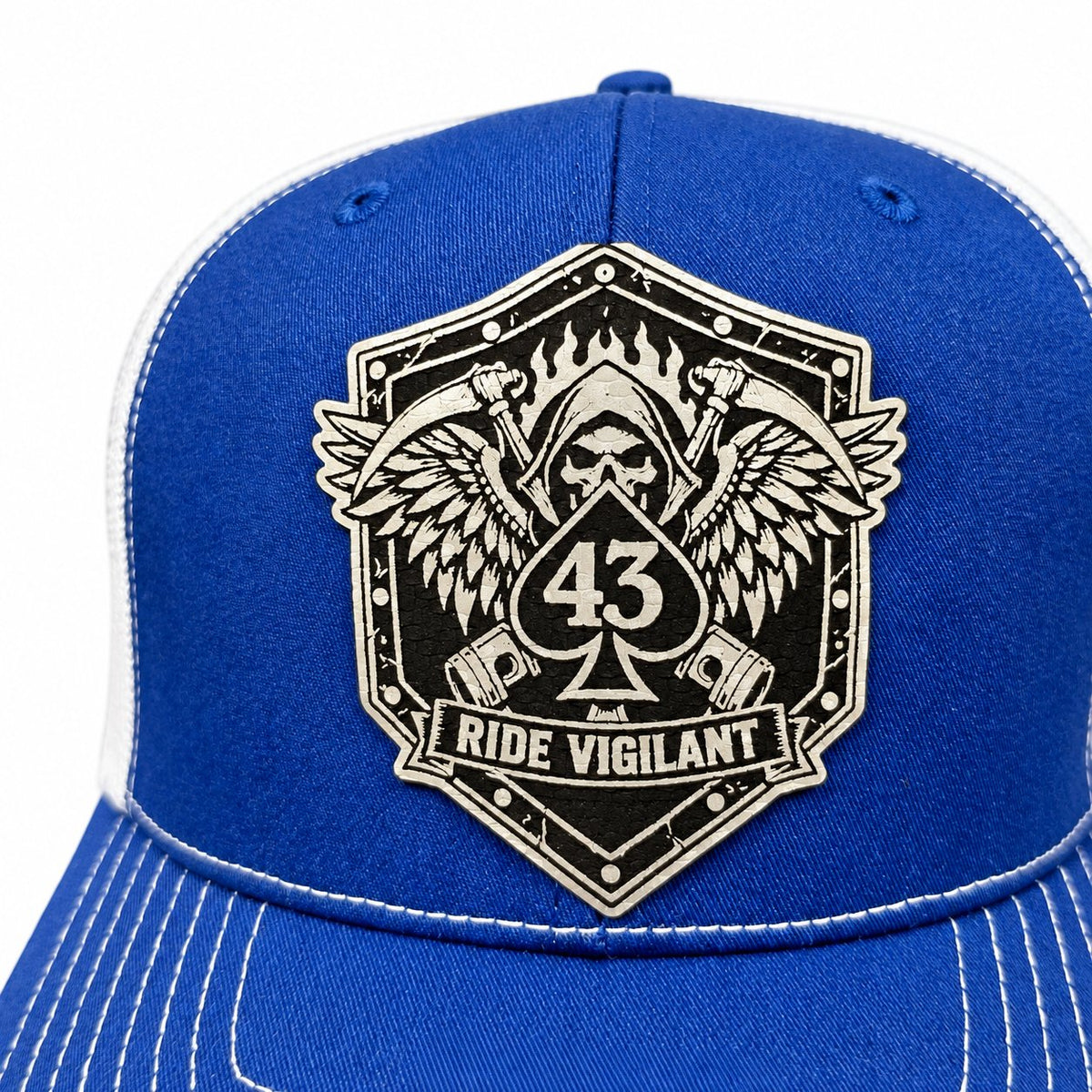 Close-up of a Ride Vigilant laser-engraved leatherette hat patch with a winged reaper and 43 spade.