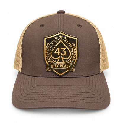 Brown and tan Richardson 112 trucker hat with a black and gold Stay Ready logo patch.