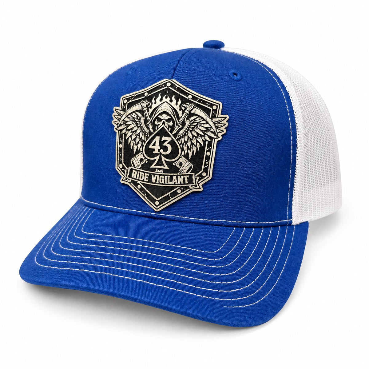 Blue and white Richardson 112 trucker hat with a laser-engraved Ride Vigilant leatherette patch featuring a 43 spade, winged reaper, and scythes.